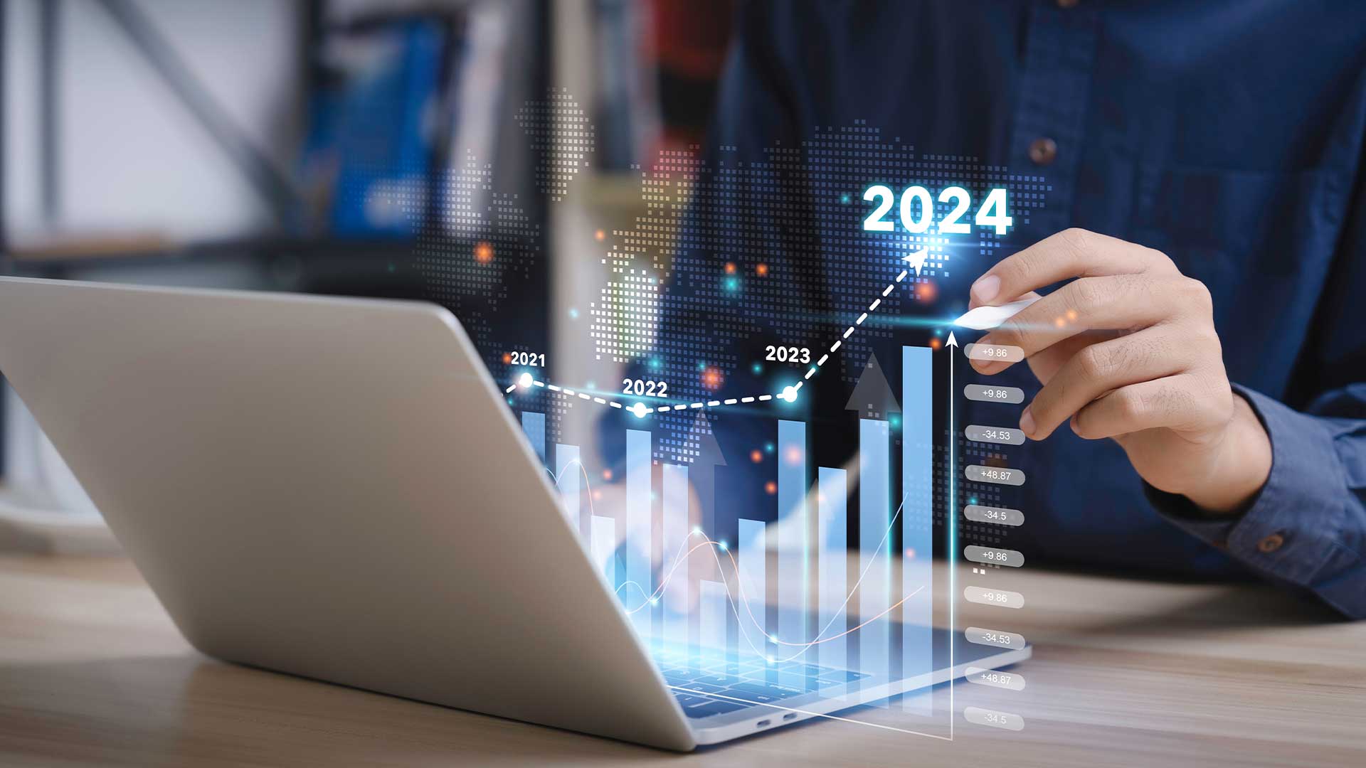 A person working on a laptop with a digital graph overlay showing upward trends for the years 2021 to 2024, symbolizing growth and progress in digital marketing Oman 2024.