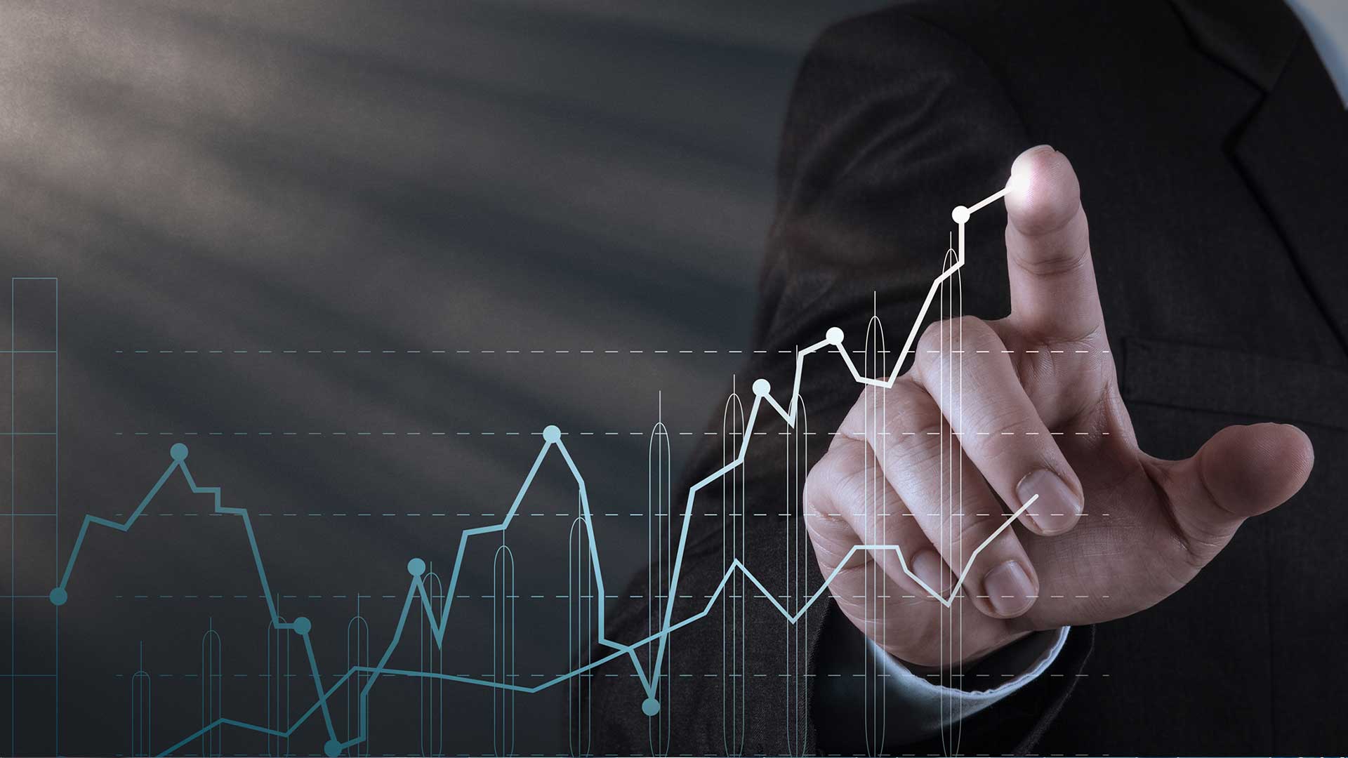 A business professional in a dark suit is pointing at a digital graph with fluctuating lines, representing financial or economic data. The image conveys a sense of analysis and progress. The title "Oman's economic growth 2024" is associated with this visual, symbolizing the anticipated economic trends and projections for Oman in 2024.