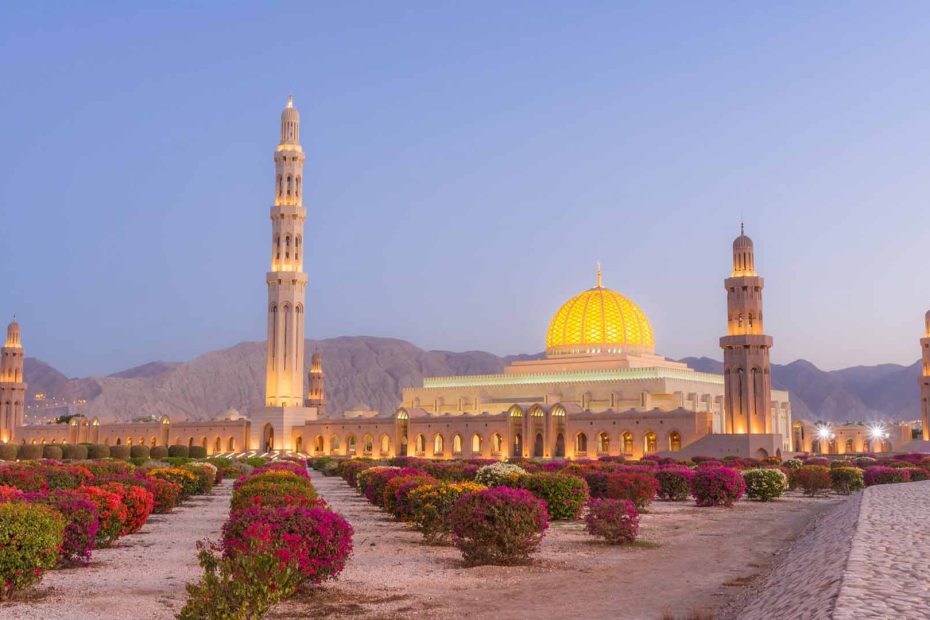 The stunning Sultan Qaboos Grand Mosque in Muscat at sunset, a highlight among the Top Oman Tourist Attractions 2024.